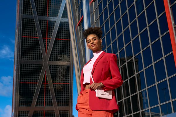 woman in red business suit standing outside